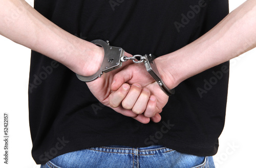 Photo: Handcuffs on Hands closeup Handcuffs on Hands closeup