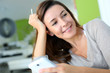 Woman at home relaxing and using smartphone