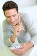 Cheerful guy using smartphone