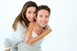 Handsome guy giving piggyback ride to girlfriend