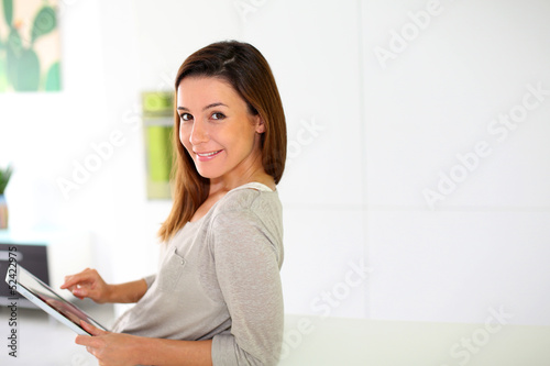 Photo: Young woman using electronic tablet Young woman using electronic tablet