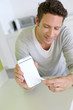 Man showing smartphone to camera