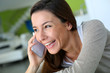 Cheerful brunette girl talking on mobile phone