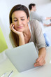 Woman at home looking at tablet screen