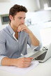 Closeup of smart guy working on laptop at home