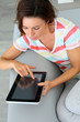 Photo: Young woman websurfing on internet with tablet Young woman websurfing on internet with tablet