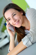 Cheerful brunette girl talking on mobile phone