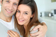 Portrait of cheerful couple standing at home