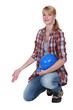 Photo: Female artisan kneeling and gesturing Female artisan kneeling and gesturing