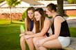 pre-teen girls texting while hanging out at their school