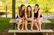 pre-teen girls texting while hanging out at their school