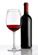 glass with red wine bottle on white background
