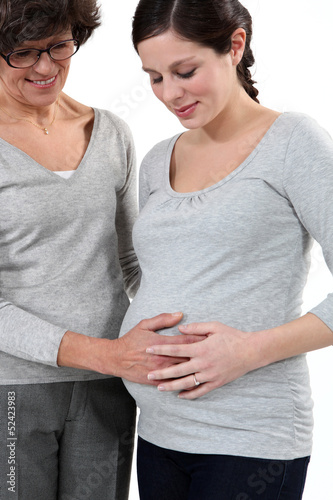 Photo: mother taking care of her pregnant daughter mother taking care of her pregnant daughter