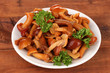 Marinated mushrooms in saucer on wooden table
