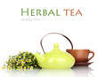 Teapot and cup with chamomile tea isolated on white