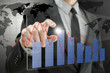 Photo: Business man pointing at interactive business graph Business man pointing at interactive business graph