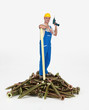 Worker standing on a pile of screws