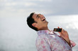 Man laughing by the water's edge