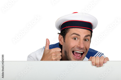 Photo: Silly sailor with a board Silly sailor with a board