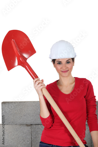 Photo: sexy craftswoman holding a shovel sexy craftswoman holding a shovel