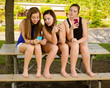 pre-teen girls texting while hanging out at their school