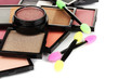 Bright eye shadows and sponge brushes for foundation close up