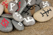 Fortune telling  with symbols on stones on burlap background