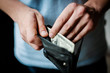 Man gets money from the wallet
