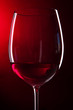 Glass of wine on bright red background