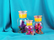 Flowering branches in glass banks blue fabric background