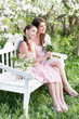 Happy mother with daughter in spring garden