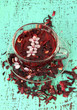 Herbal tea in glass cup, on color wooden background
