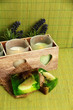 Candles in wooden candlestick, lavender and soap, on green mat