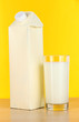 Milk pack on table on yellow background