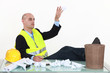 Photo: An architect throwing drafts in the garbage cans. An architect throwing drafts in the garbage cans.
