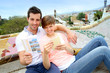 Tourists reading travel book in Guell Park, Barcelona