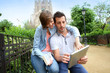 Couple of tourists using tablet in Barcelona