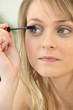 a woman putting mascara