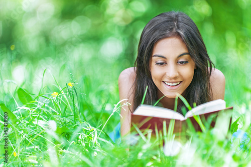 Photo: dark-haired young woman reading red book dark-haired young woman reading red book