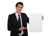 Foto: Businessman with a blank board Businessman with a blank board