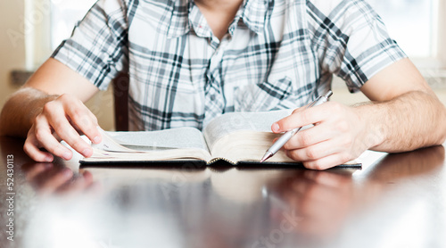 Photo: Hispanic teenager reading the Bible Hispanic teenager reading the Bible