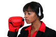 Woman with audio helmet and boxing gloves