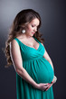 Pretty pregnant woman caressing her belly