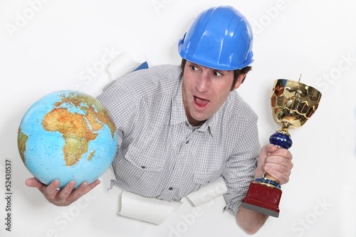 Photo: Laborer with globe and cup in hands Laborer with globe and cup in hands