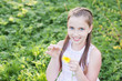 Photo: smiling girl wonders on flower, tearing petals, smiling girl wonders on flower, tearing petals,