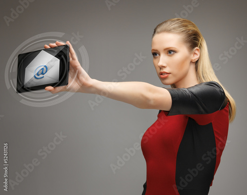 Photo: woman with tablet pc and email icon woman with tablet pc and email icon