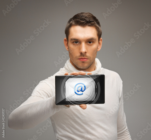Photo: man holding tablet pc with email icon man holding tablet pc with email icon