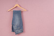 A blue jeans are on hanger.