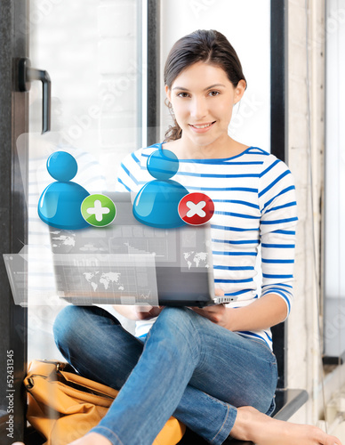 Photo: girl with laptop and contact icons girl with laptop and contact icons