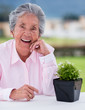 Elder woman with a plant